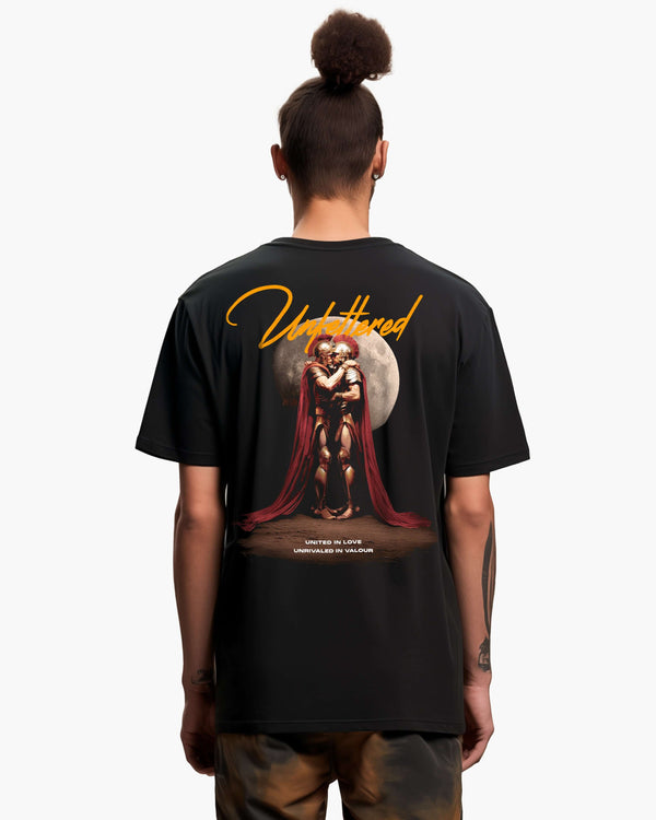 Model shot showing back of black t-shirt featuring large Sacred Band of Thebes graphic of 2 warriors kissing